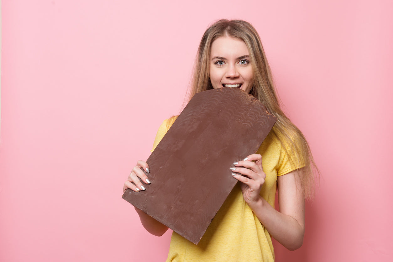 Girl eating giant chocolate bar